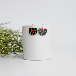 Black half circles with red and green dots