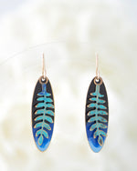 Hand patinaed ferns over shades of black and blues
