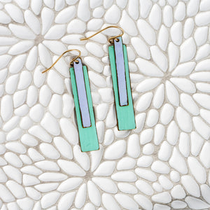 Layered brass bars in purple and aqua green/blue